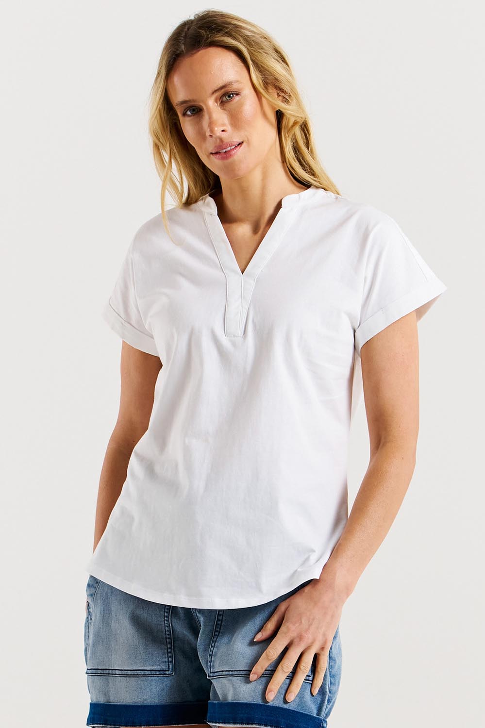 A model wearing the Bridie Cotton Tee in colour White (White), from the front, cropped image