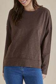 A model wearing the Roxette Cotton Tee in colour Chocolate, from the front, cropped image