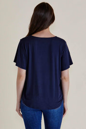 A model wearing the Everleigh Bamboo Tee in colour Navy (Blue), from the back