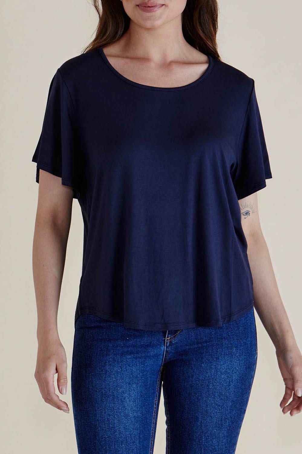 A model wearing the Everleigh Bamboo Tee in colour Navy (Blue), from the front, cropped image