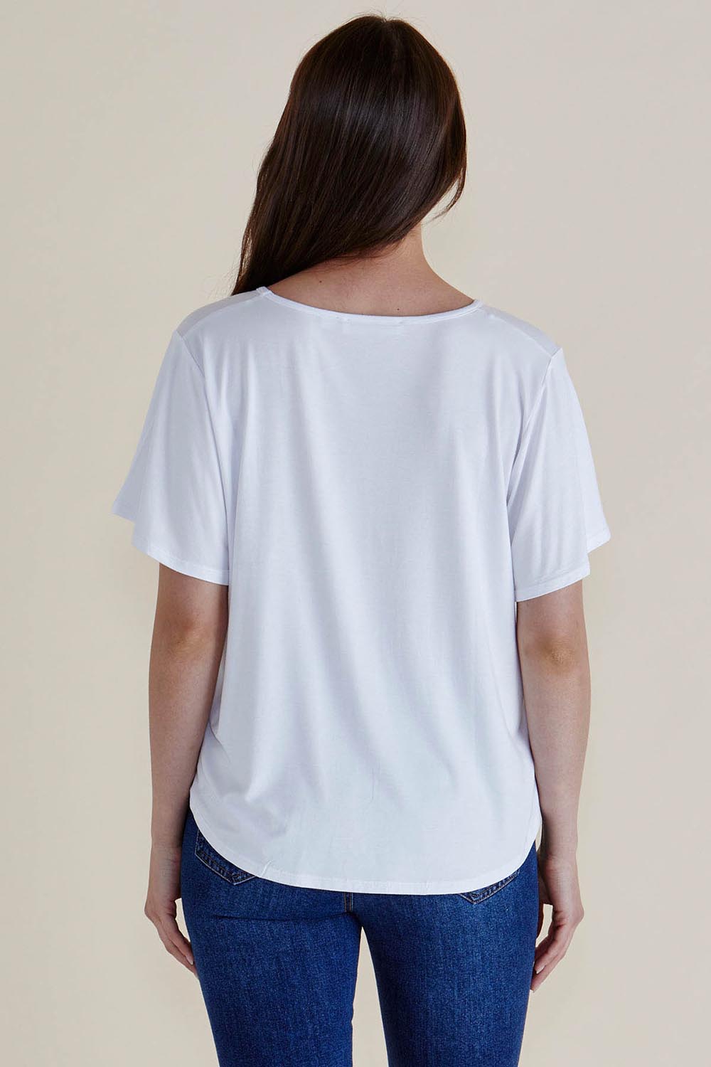 A model wearing the Everleigh Bamboo Tee in colour White (White), from the back