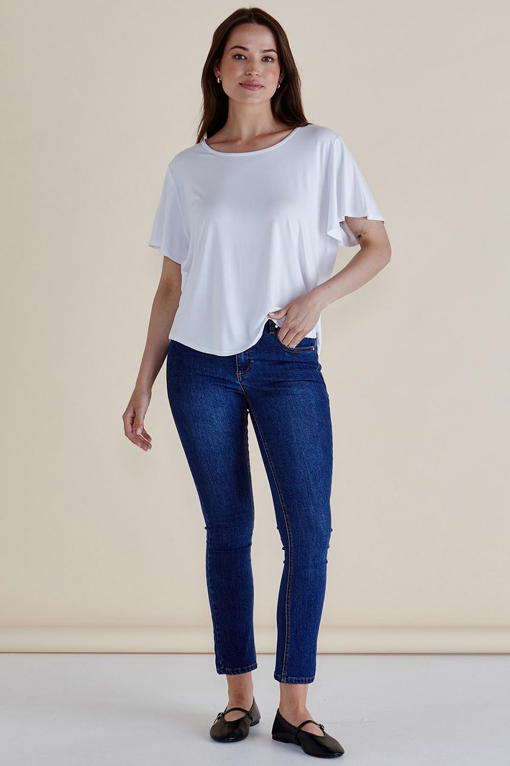 A model wearing the Everleigh Bamboo Tee in colour White (White), from the front, showing the whole outfit