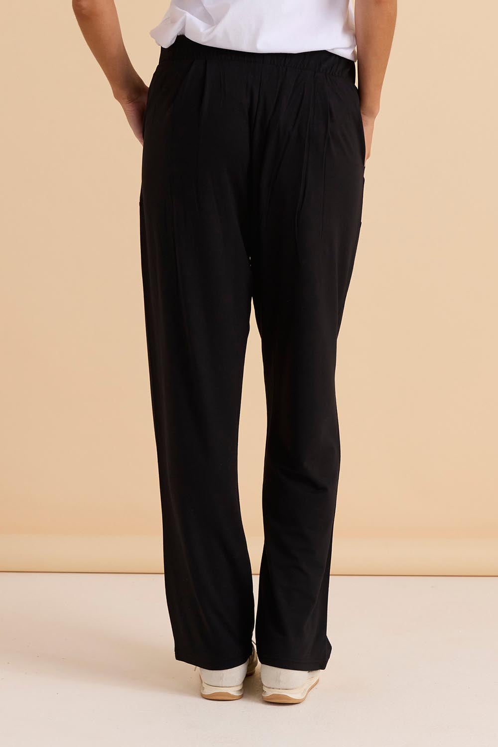 A model wearing the Ginnie Bamboo Pant in colour Black (Black), from the back