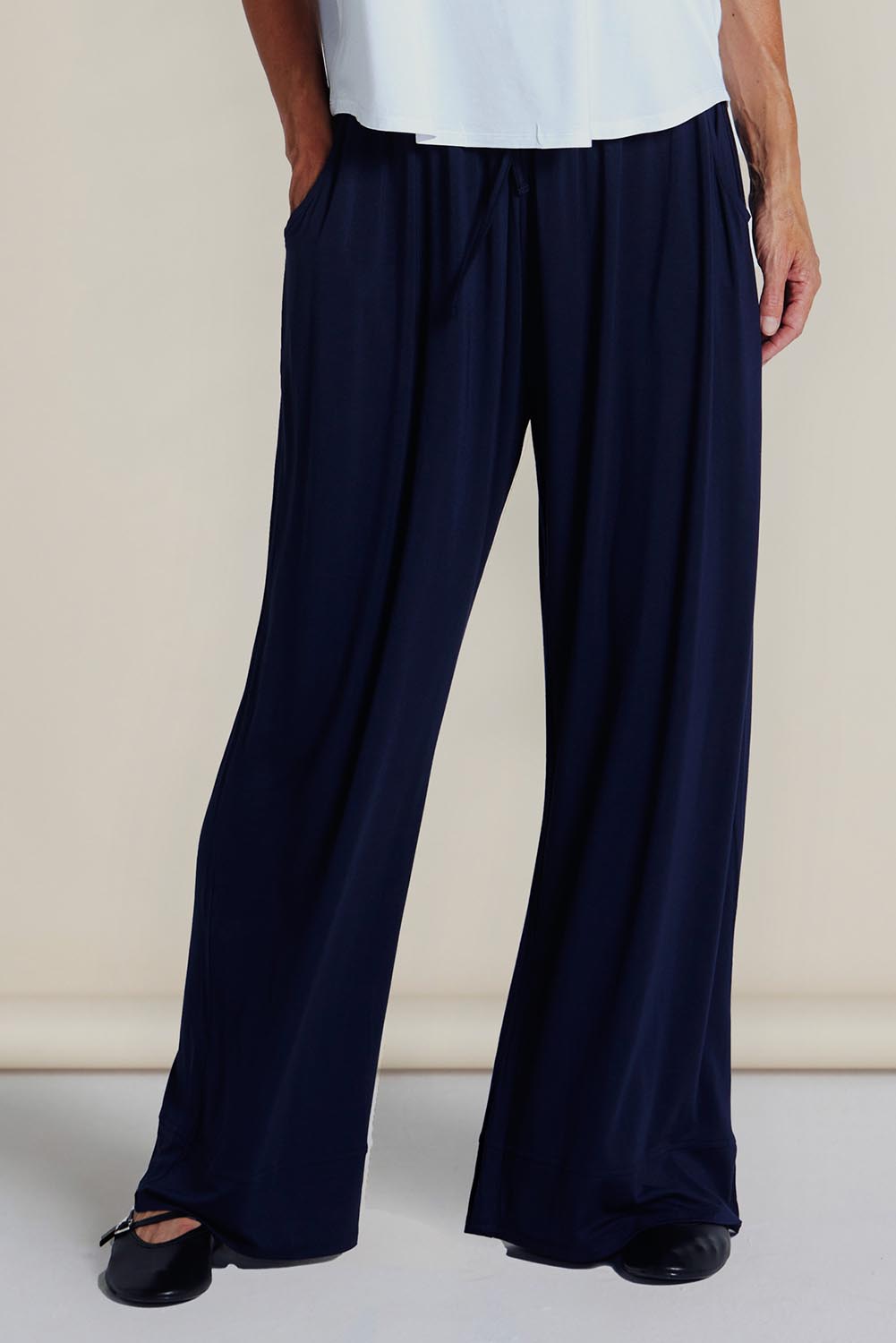 A model wearing the Ginnie Bamboo Pant in colour Navy (Blue), from the front, showing the whole outfit