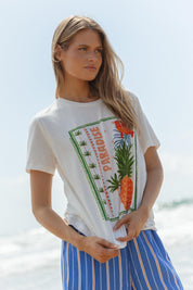 A model wearing the Ellia Cotton Crew Tee in colour Paradise (White), from the front, showing the whole outfit
