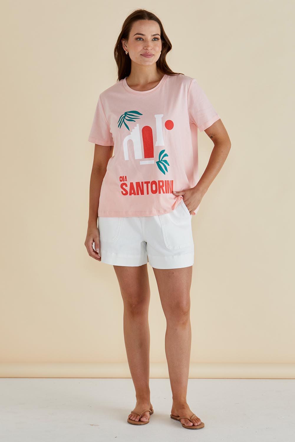 A model wearing the Ellia Cotton Crew Tee in colour Santorini (Pink), from the front, showing the whole outfit