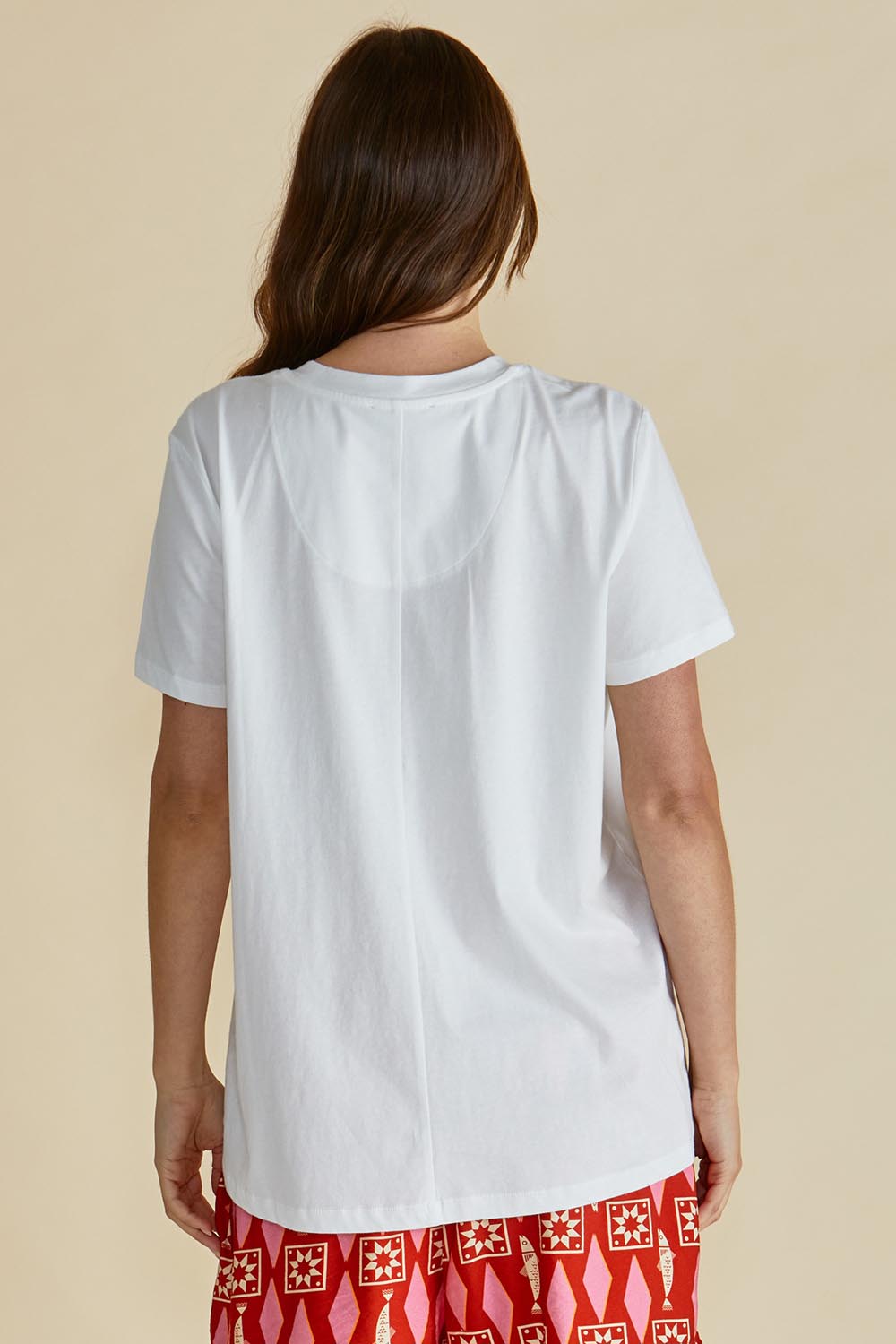 A model wearing the Ellia Cotton Crew Tee in colour Sardinia (White), from the back