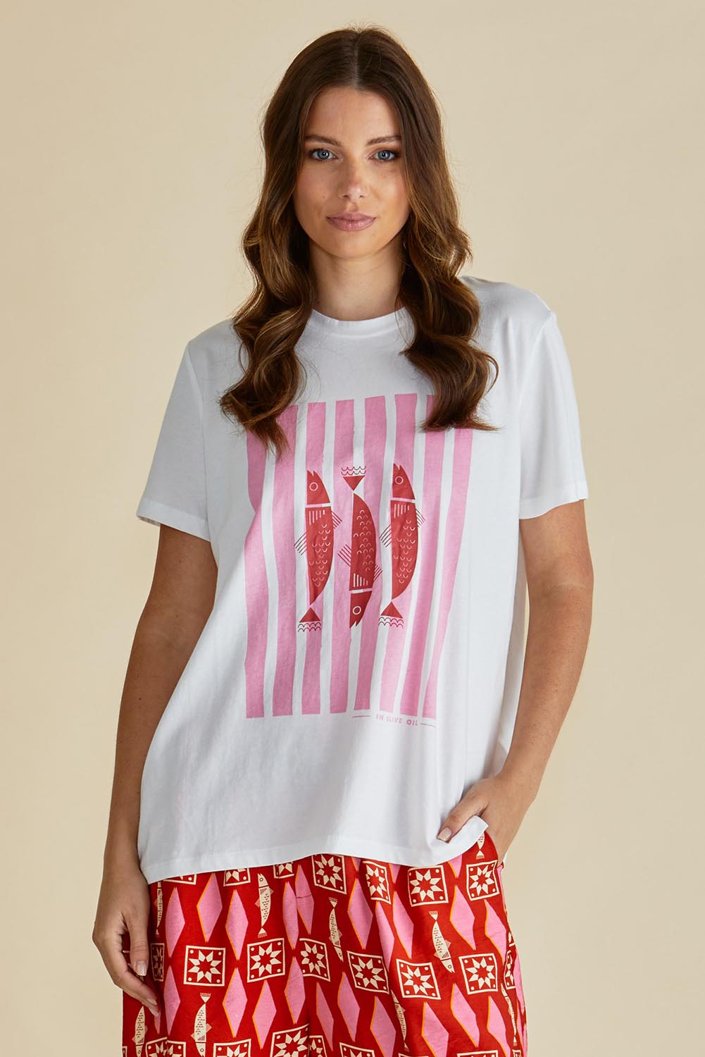 A model wearing the Ellia Cotton Crew Tee in colour Sardinia (White), from the front, cropped image