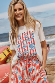 Model Genericm wearing size sample of the Ellia Crew Tee – Sunsea in colour Sunsea, in a cropped view