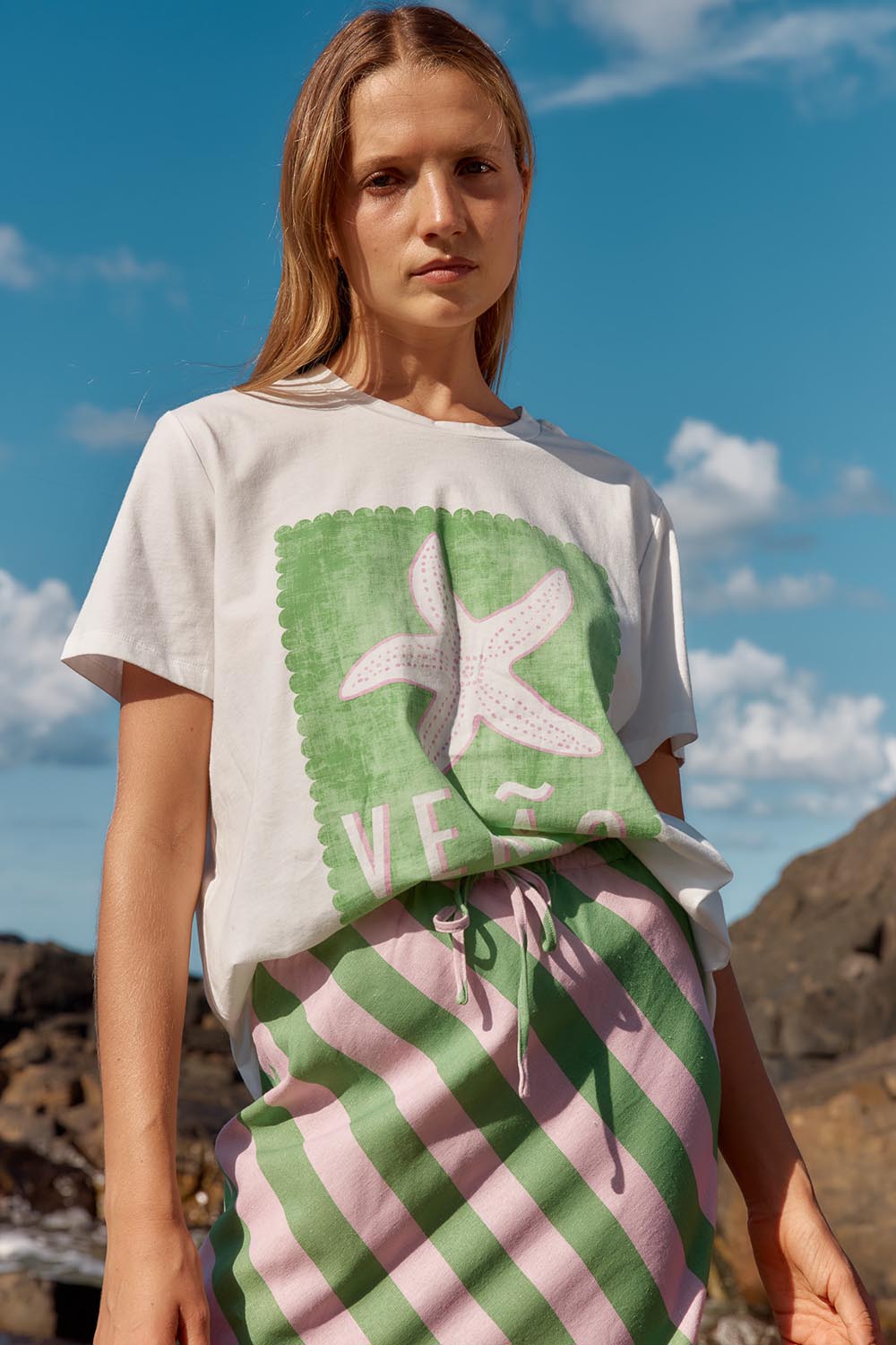 A model wearing the Ellia Cotton Crew Tee in colour Verao (Green), from the front, showing the whole outfit