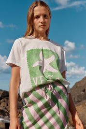 A model wearing the Ellia Cotton Crew Tee in colour Verao (Green), from the front, showing the whole outfit