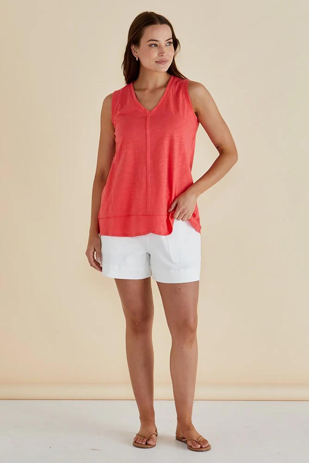 A model wearing the Mariah Cotton Tank in colour Grapefruit (Pink), from the front, showing the whole outfit