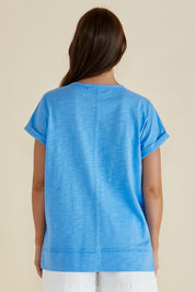 A model wearing the Shirley Cotton Short Sleeve Tee in colour Blue (Blue), from the back