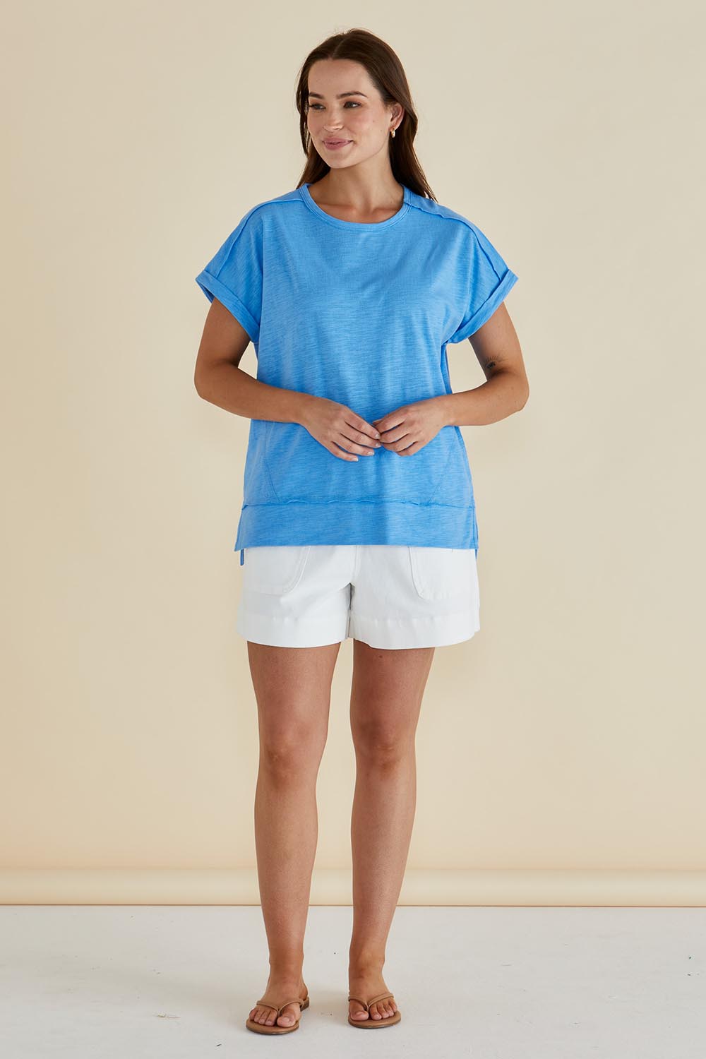 A model wearing the Shirley Cotton Short Sleeve Tee in colour Blue (Blue), from the front, showing the whole outfit