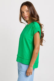 Model Genericm wearing size sample of the Shirley Short Sleeve Tee – Green in colour Green, from an angle