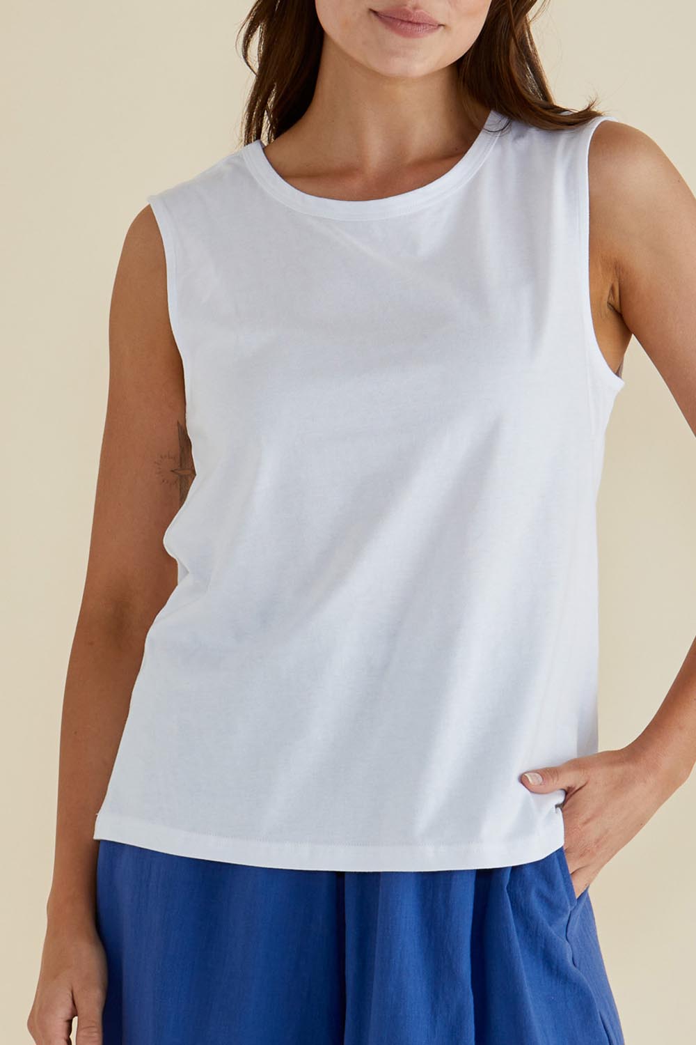 A model wearing the Jordyn Cotton Tank in colour White (White), from the front, cropped image
