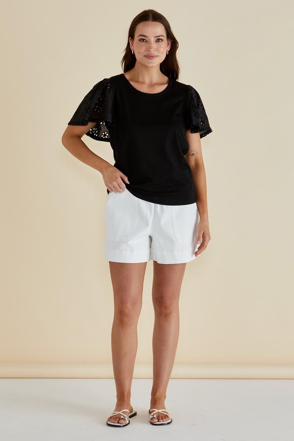 A model wearing the Lottie Embroidered Cotton Tee in colour Black (Black), from the front, showing the whole outfit