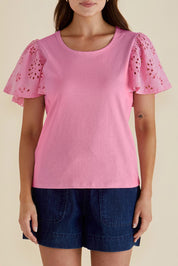 A model wearing the Lottie Embroidered Cotton Tee in colour Pink (Pink), from the front, cropped image