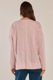 A model wearing the Beatris Tee in colour Pink (Pink), from the back