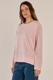 A model wearing the Beatris Tee in colour Pink (Pink), from the front, cropped image