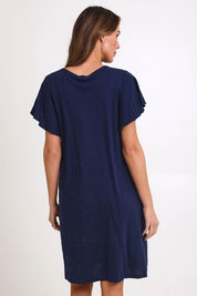 Model Madelinec wearing size 10 of the Celene Frill Dress – Navy in colour Navy, from the back