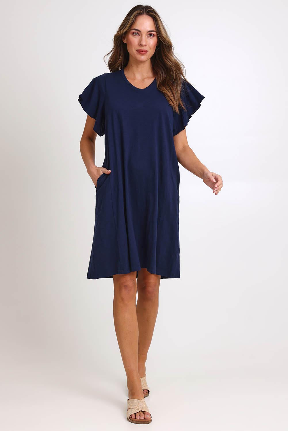 Model Madelinec wearing size 10 of the Celene Frill Dress – Navy in colour Navy, from the front
