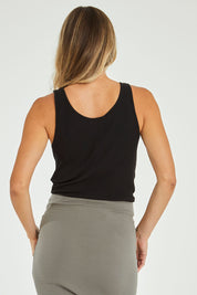 Model Alice wearing size 10 of the Mimi Rib Tank in colour Black (Black), from the back