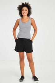 Model Olivia wearing size 10 of the Mimi Rib Tank in colour Whiteblack (White), from the front, showing the whole outfit