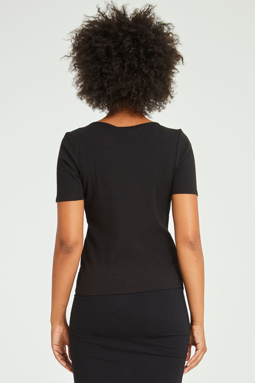 Model Olivia wearing size 10 of the Stacey Rib Tee in colour Black (Black), from the back