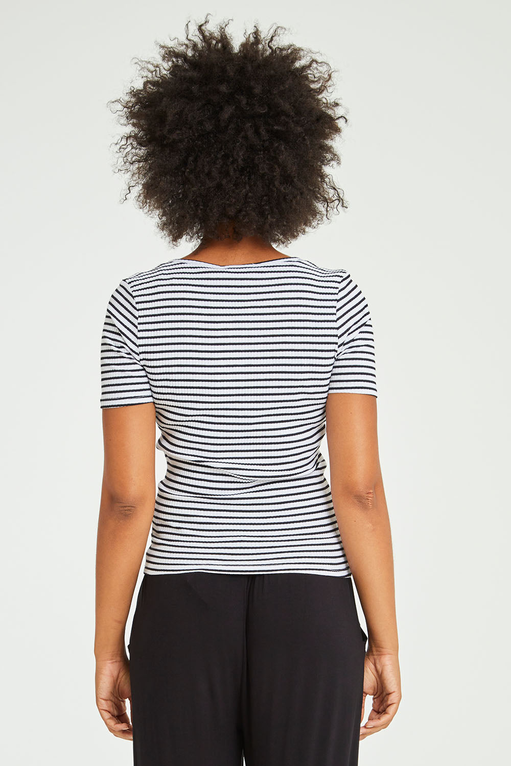 Model Olivia wearing size 10 of the Stacey Rib Tee in colour Whiteblack (White), from the back