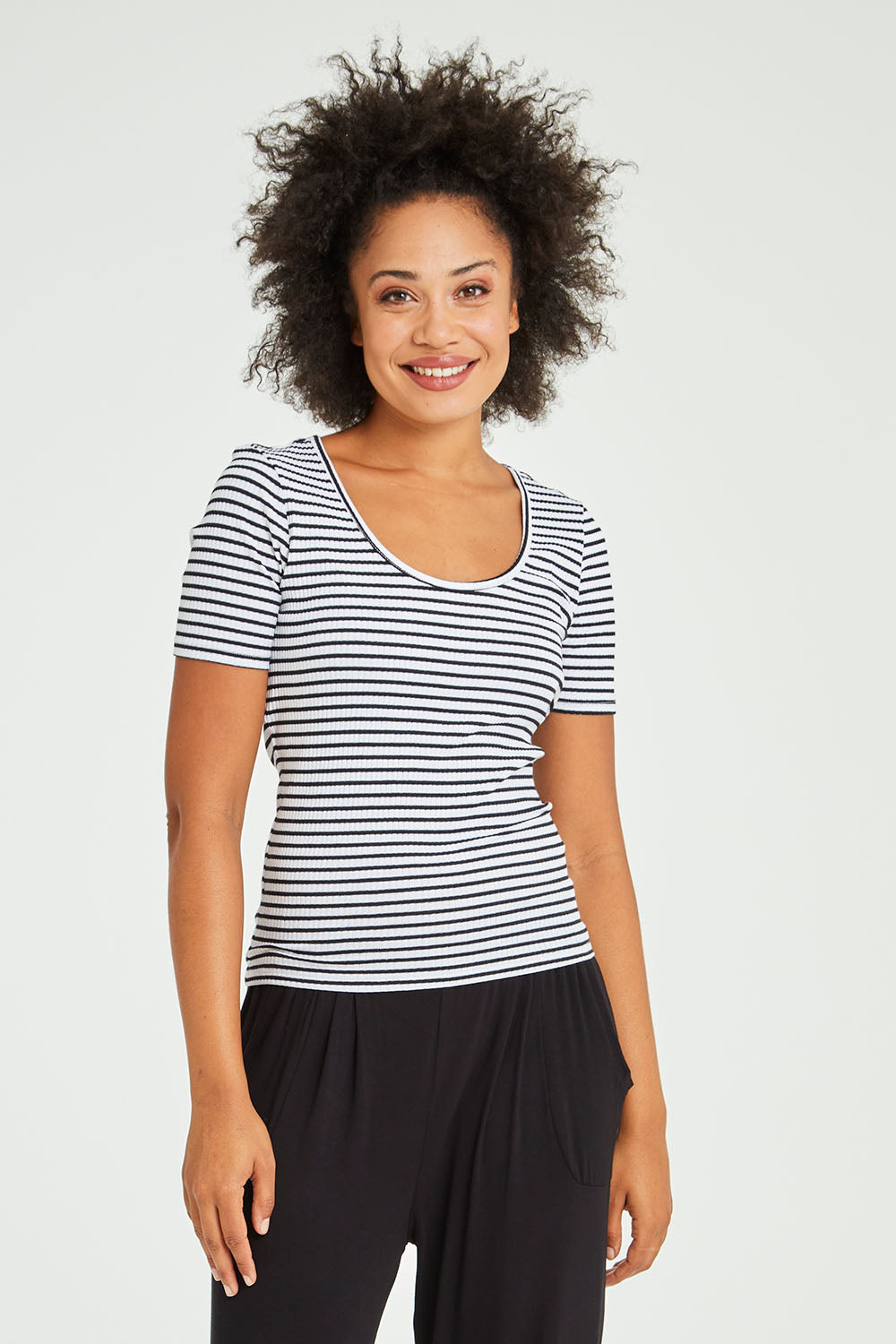 Model Olivia wearing size 10 of the Stacey Rib Tee in colour Whiteblack (White), from the front, cropped image