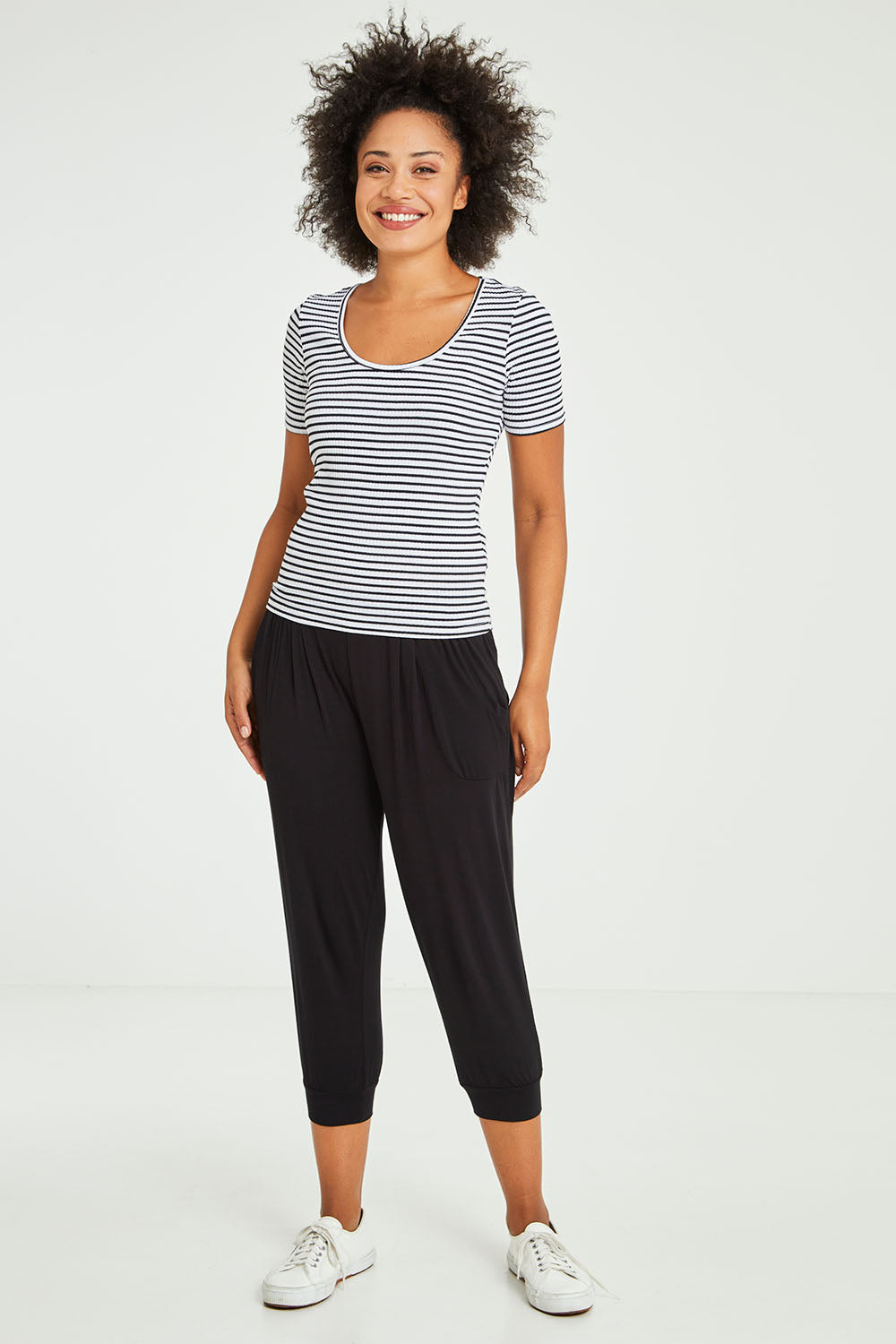 Model Olivia wearing size 10 of the Stacey Rib Tee in colour Whiteblack (White), from the front, showing the whole outfit