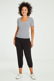 Model Olivia wearing size 10 of the Stacey Rib Tee in colour Whiteblack (White), from the front, showing the whole outfit