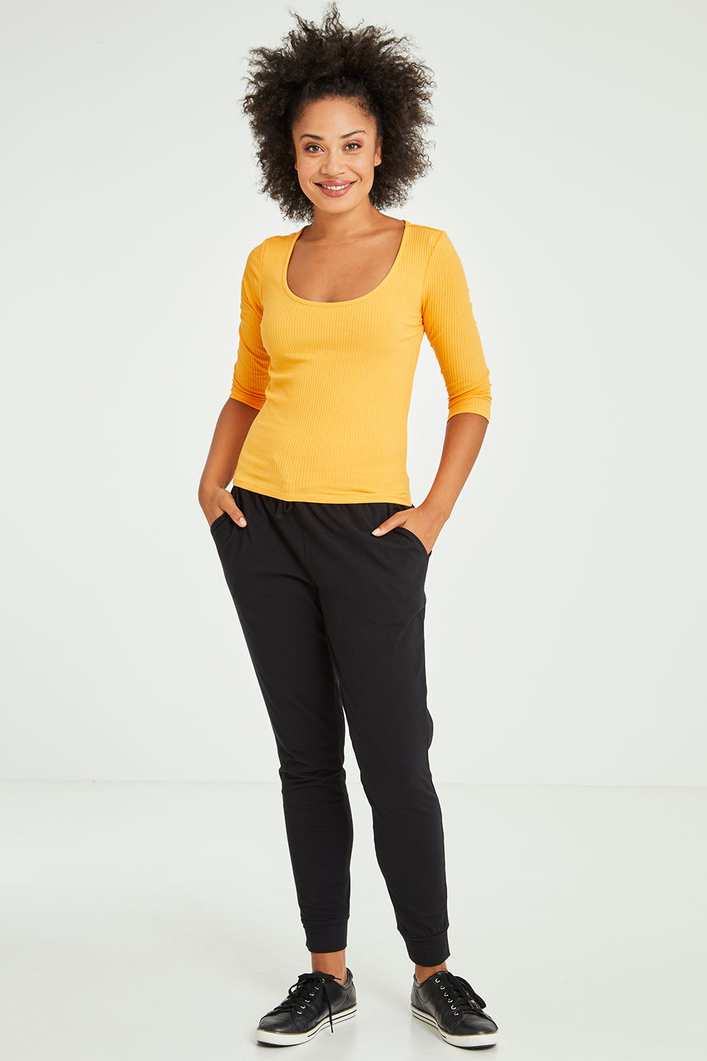 Model Olivia wearing size 10 of the Rosa 3/4 Rib Top in colour Mandarin, from the front, showing the whole outfit