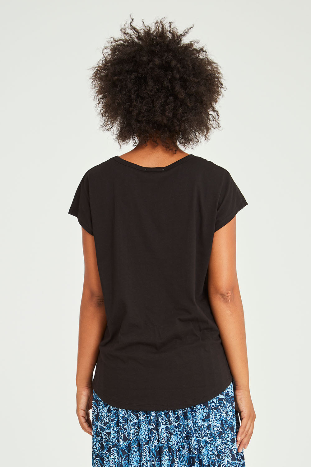 Model Olivia wearing size 10 of the Tyra Top in colour Black (Black), from the back