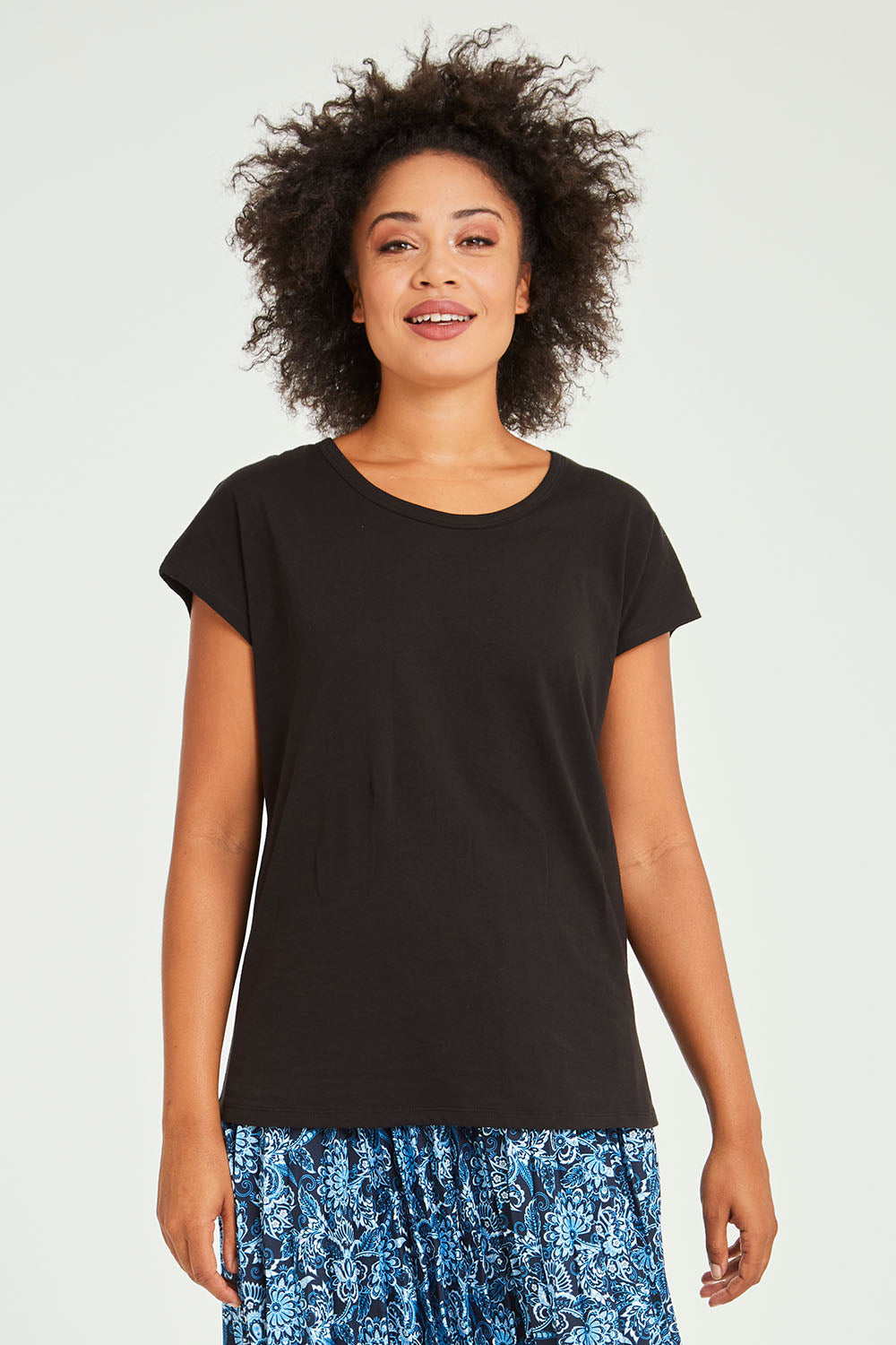 Model Olivia wearing size 10 of the Tyra Top in colour Black (Black), from the front, cropped image
