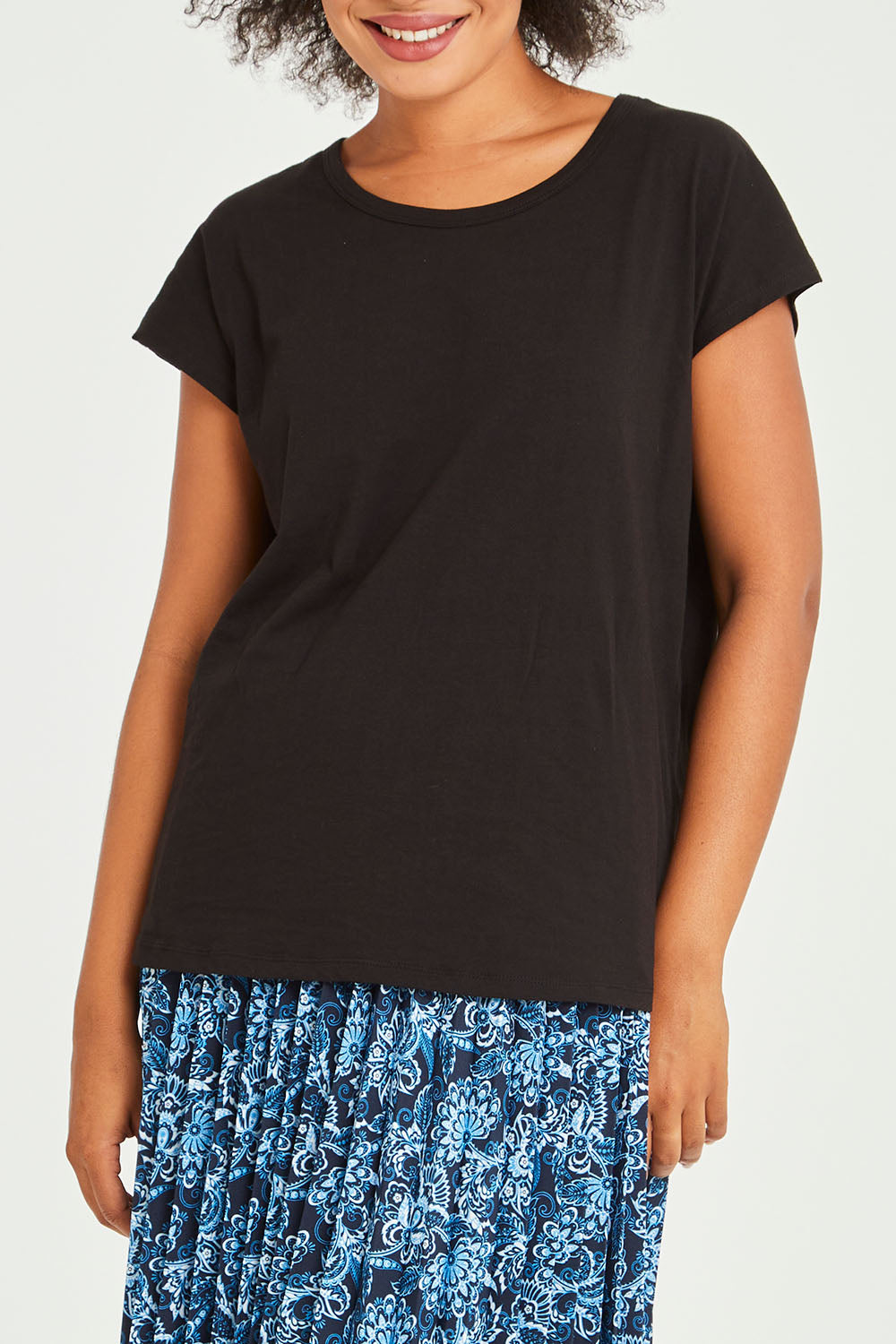 Model Olivia wearing size 10 of the Tyra Top in colour Black (Black), from the front, cropped image
