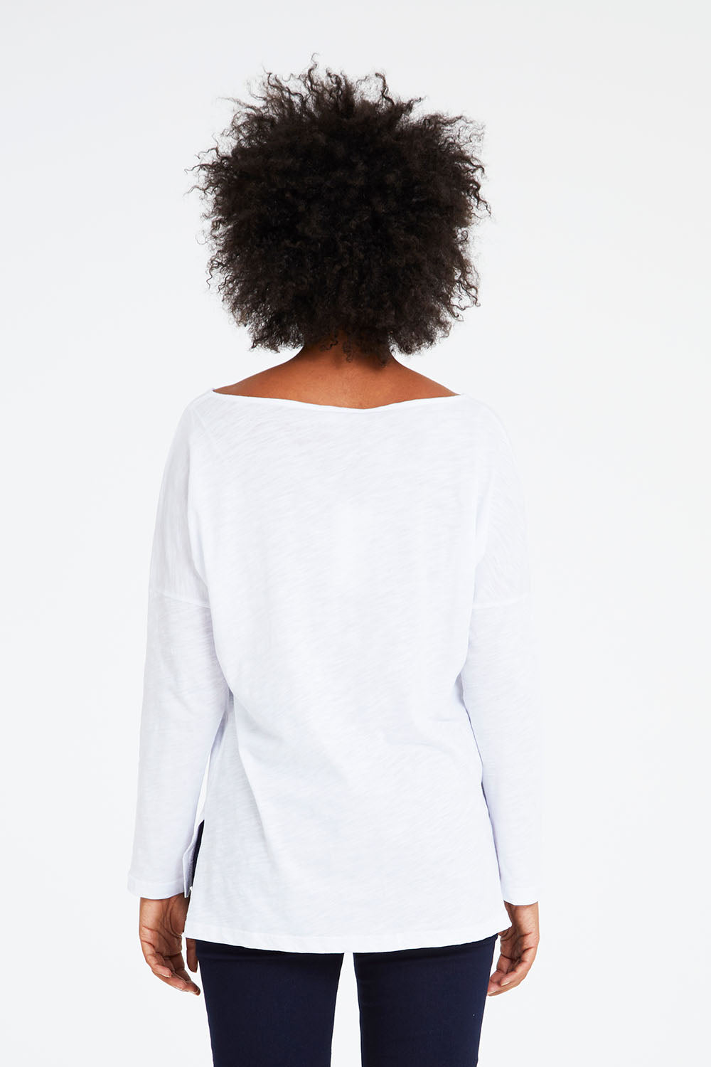 Model Olivia wearing size 10 of the Monique Top in colour White (White), from the back