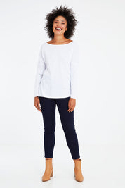 Model Olivia wearing size 10 of the Monique Top in colour White (White), from the front, showing the whole outfit