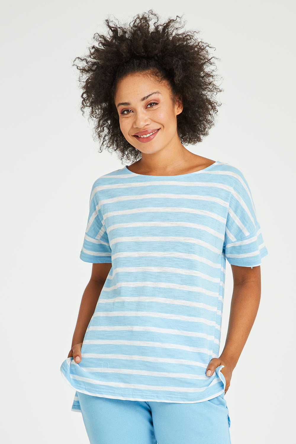Model Olivia wearing size 10 of the Kathy Tee in colour Bluestripe (Blue), from the front, cropped image