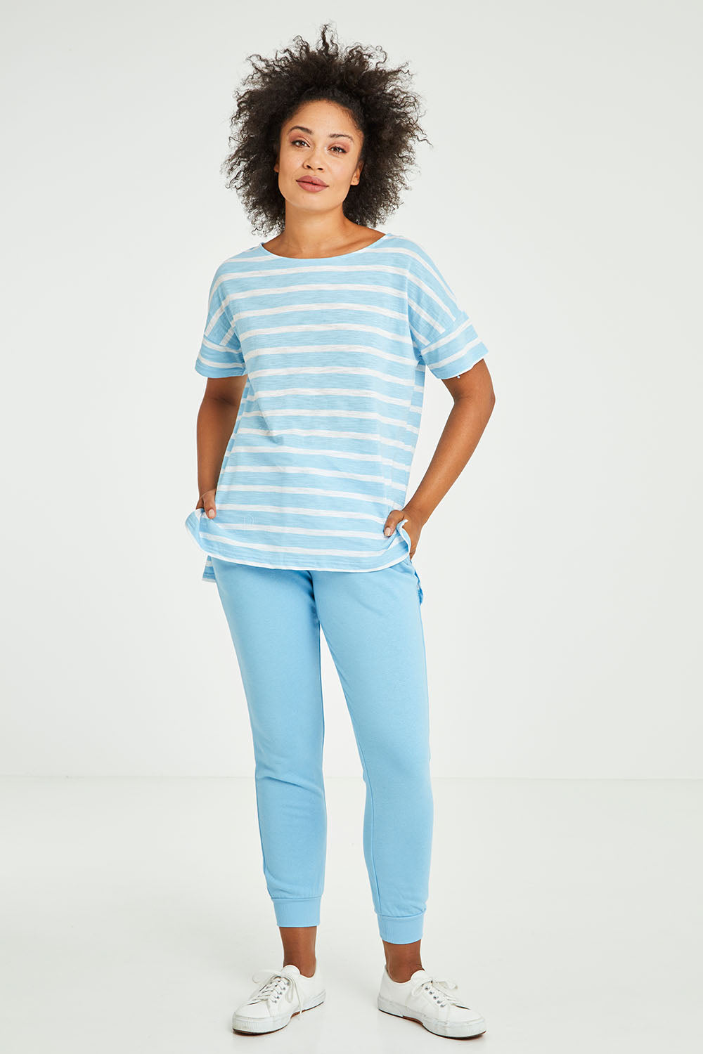 Model Olivia wearing size 10 of the Kathy Tee in colour Bluestripe (Blue), from the front, showing the whole outfit