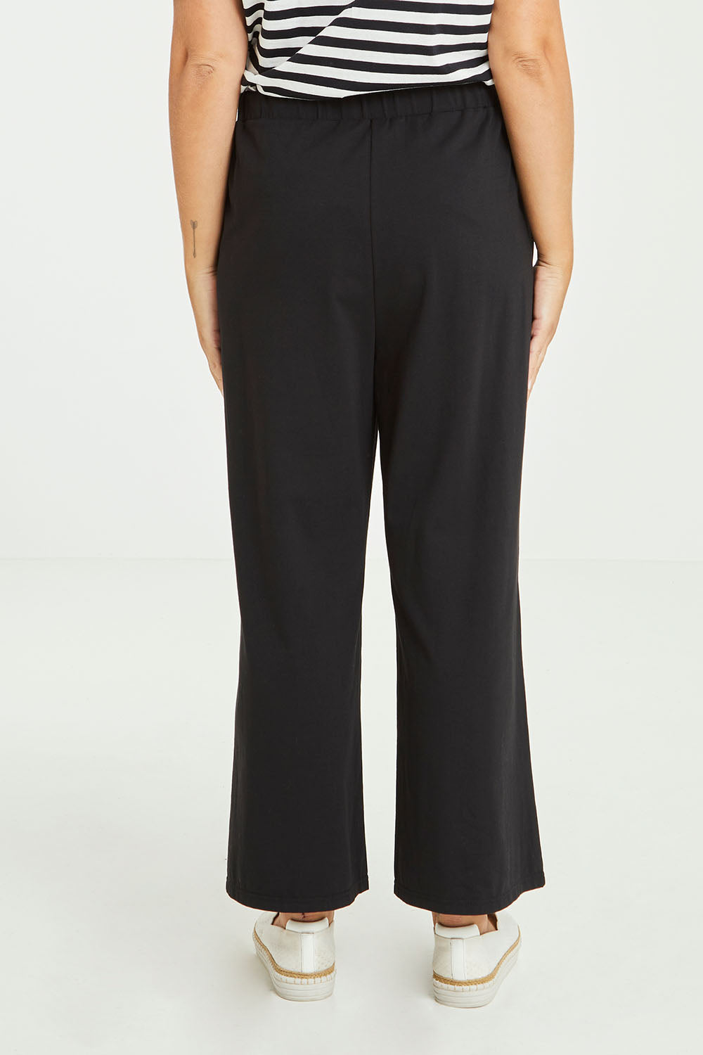 Model Tahlia wearing size 10 of the Dasha Pant in colour Black (Black), from the back