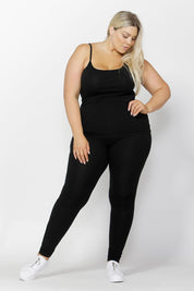 A model wearing the Tina Singlet in colour Black (Black), from the front, showing the whole outfit