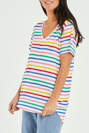 Model Katie wearing size 10 of the Ava Tee in colour Rainbow (Blue), from the front, cropped image