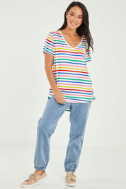 Model Katie wearing size 10 of the Ava Tee in colour Rainbow (Blue), from the front, showing the whole outfit