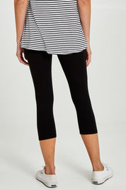 Model Madeline wearing size 10 of the Leia Crop Legging in colour Black (Black), from the back