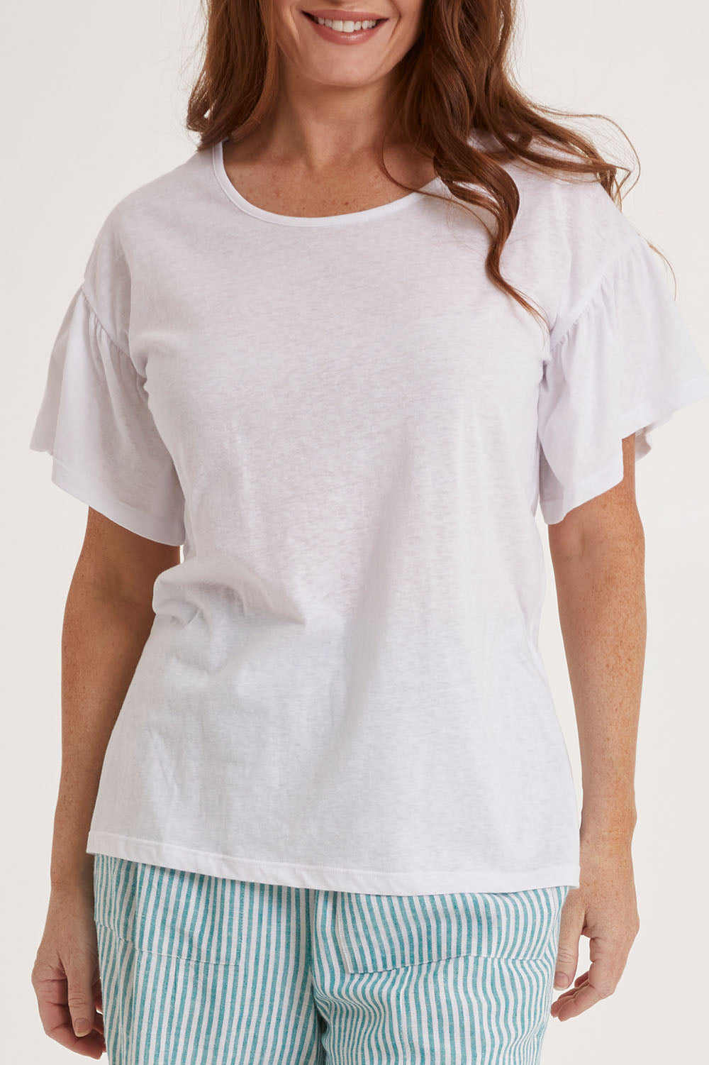 Model Sally wearing size 10 of the Alessi Frill Top in colour White (White), from the front, cropped image