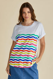 A model wearing the Hailey Short Sleeve Cotton Tee in colour Rainbow, from the front, cropped image