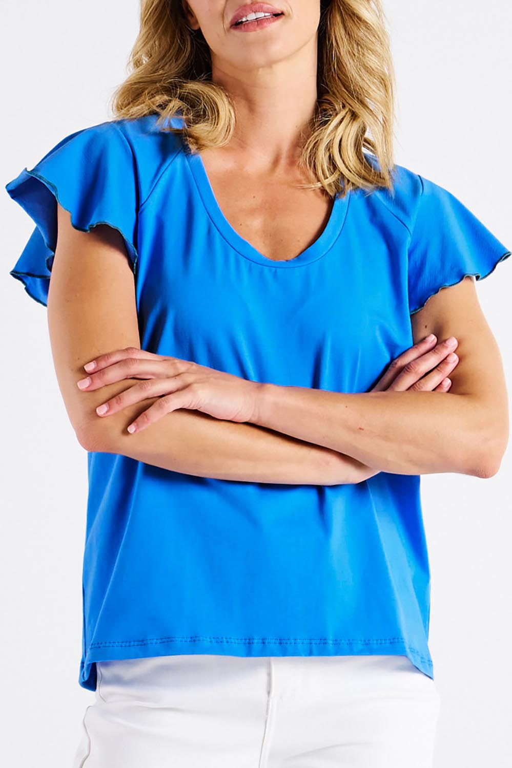 A model wearing the Magnolia Cotton Frill Sleeve Top in colour Powderblue (Blue), from the front, cropped image