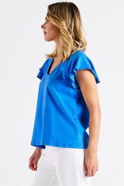 A model wearing the Magnolia Cotton Frill Sleeve Top in colour Powderblue (Blue), from the front, cropped image
